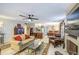 Bright living room seamlessly connects to kitchen and dining areas, featuring fireplace, plush seating, and natural light at 11144 N 109Th Way, Scottsdale, AZ 85259