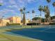 Well-maintained tennis court surrounded by mature palm trees at 11144 N 109Th Way, Scottsdale, AZ 85259