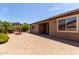 Wide angle view of brick paved backyard with trees, and exterior of home at 11952 W Overlin Ln, Avondale, AZ 85323
