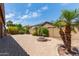 The large backyard has block wall fencing and is highlighted by a brick fire pit at 11952 W Overlin Ln, Avondale, AZ 85323