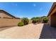 Spacious backyard features brick flooring, mature trees, and perimeter block fence at 11952 W Overlin Ln, Avondale, AZ 85323