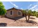 View of block home with tiled roof, brick landscaping, and desert rock at 11952 W Overlin Ln, Avondale, AZ 85323