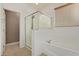 Bright bathroom features a glass enclosed shower, a tub, and a window at 11952 W Overlin Ln, Avondale, AZ 85323