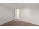 View of a bedroom with an open door and white closet doors in a home at 11952 W Overlin Ln, Avondale, AZ 85323