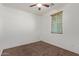 View of a bedroom with a ceiling fan, window with blinds and neutral colored carpet at 11952 W Overlin Ln, Avondale, AZ 85323