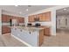 Well-equipped kitchen featuring stainless appliances, granite countertops, and center island with sink at 11952 W Overlin Ln, Avondale, AZ 85323