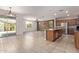 Open floor plan showcases kitchen with stainless steel appliances, stone accent wall, and tiled floors at 11952 W Overlin Ln, Avondale, AZ 85323