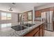 Detailed view of a kitchen island featuring granite countertops and stainless sink and fixtures at 11952 W Overlin Ln, Avondale, AZ 85323