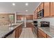 Modern kitchen featuring stainless steel appliances, granite counters, and ample cabinetry at 11952 W Overlin Ln, Avondale, AZ 85323