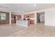 Open kitchen with granite counters, stainless appliances, and island with sink, flowing into a living area at 11952 W Overlin Ln, Avondale, AZ 85323
