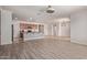 Spacious living room with wood-style flooring, bright lighting, and neutral walls at 11952 W Overlin Ln, Avondale, AZ 85323