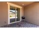 Cozy covered patio features brick flooring, a sliding glass door, and a barbecue grill at 11952 W Overlin Ln, Avondale, AZ 85323