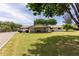 Lush green backyard featuring a spacious lawn and a covered patio with outdoor seating and a grill at 12548 E Cloud Rd, Chandler, AZ 85249
