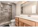 This bathroom features a wood look shower, modern vanity, and stone flooring at 12548 E Cloud Rd, Chandler, AZ 85249