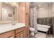 Charming bathroom with tile floors, wood cabinetry, vanity sink, soaking tub, and separate shower at 12548 E Cloud Rd, Chandler, AZ 85249