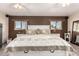 Primary bedroom featuring neutral tones, tile floors, natural light, and three ceiling fans at 12548 E Cloud Rd, Chandler, AZ 85249