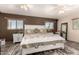 Spacious main bedroom with tile floors, plenty of natural light, two windows, and a decorative rug at 12548 E Cloud Rd, Chandler, AZ 85249
