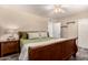 Bedroom featuring neutral colors, tile floors, ceiling fan, natural light, and decorative bedside table at 12548 E Cloud Rd, Chandler, AZ 85249