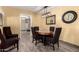 Cozy dining room with seating for six, featuring elegant light fixture and a wall mirror at 12548 E Cloud Rd, Chandler, AZ 85249