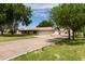 Spacious driveway leading to a charming home with mature trees and landscaping at 12548 E Cloud Rd, Chandler, AZ 85249