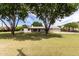 Charming single-story home surrounded by mature trees and lush greenery at 12548 E Cloud Rd, Chandler, AZ 85249