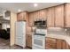 Modern kitchen with wood cabinets, stainless microwave, and tile backsplash at 12548 E Cloud Rd, Chandler, AZ 85249
