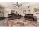 Cozy living room with comfortable seating, tile floors, ceiling fan, and view of a treadmill at 12548 E Cloud Rd, Chandler, AZ 85249