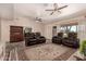 Bright and airy living room with three ceiling fans, tile floors, and a decorative rug at 12548 E Cloud Rd, Chandler, AZ 85249