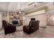 Inviting living room with leather seating, stone fireplace, and wood-look flooring at 12548 E Cloud Rd, Chandler, AZ 85249