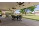 This patio has an outdoor seating area overlooking the spacious lawn at 12548 E Cloud Rd, Chandler, AZ 85249