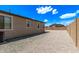 Backyard featuring a rock ground cover and tan block perimeter wall, sunny sky above at 1268 E Jahns Dr, Casa Grande, AZ 85122