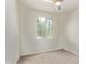 A bright bedroom features neutral carpet, a ceiling fan, and large windows for ample natural light at 1268 E Jahns Dr, Casa Grande, AZ 85122