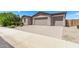 Tan home featuring a two-car garage, beautiful landscaping, and a brick driveway at 1268 E Jahns Dr, Casa Grande, AZ 85122