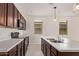 Kitchen featuring white countertops, pendant lighting, stainless sink, and dark wood cabinetry at 1268 E Jahns Dr, Casa Grande, AZ 85122