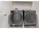 Laundry room featuring gray Samsung washer and dryer set on gray wood-look floor at 1268 E Jahns Dr, Casa Grande, AZ 85122