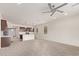 Open floor plan of living room leading to kitchen featuring luxury vinyl plank flooring and a ceiling fan at 1268 E Jahns Dr, Casa Grande, AZ 85122