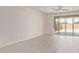Open floor plan of living room leading to backyard featuring luxury vinyl plank flooring and sliding glass doors at 1268 E Jahns Dr, Casa Grande, AZ 85122