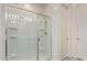 A clean and bright shower features a glass door, built-in shelves, and modern fixtures at 1268 E Jahns Dr, Casa Grande, AZ 85122