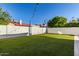 Backyard featuring a privacy wall, artificial lawn, string lights, and patio at 1349 N Lakeshore Dr, Chandler, AZ 85226