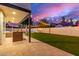 Outdoor living with travertine patio, artificial turf, string lights, and ample space at 1349 N Lakeshore Dr, Chandler, AZ 85226