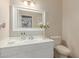 Cozy half-bathroom featuring a bright white vanity and a decorative mirror at 1349 N Lakeshore Dr, Chandler, AZ 85226