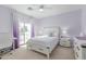 Bedroom featuring a queen bed, purple accent wall, and sliding door to the outside at 1349 N Lakeshore Dr, Chandler, AZ 85226