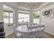 Bright dining area featuring a chandelier and large windows overlooking the backyard at 1349 N Lakeshore Dr, Chandler, AZ 85226