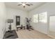 Bright workout room with carpet, window, stationary bike, and weight machine at 1349 N Lakeshore Dr, Chandler, AZ 85226