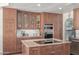 Beautiful kitchen featuring custom wood cabinetry, granite countertops, and modern stainless steel appliances at 1349 N Lakeshore Dr, Chandler, AZ 85226