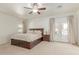 Spacious main bedroom featuring a private outdoor entrance, neutral colors, and a ceiling fan at 1349 N Lakeshore Dr, Chandler, AZ 85226