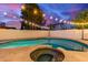 Inviting pool and spa with travertine surround and string lights create an outdoor oasis at 1349 N Lakeshore Dr, Chandler, AZ 85226