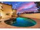 Sparkling pool with travertine deck and string lights creates a resort-like backyard atmosphere at 1349 N Lakeshore Dr, Chandler, AZ 85226
