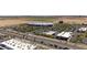 Aerial view showcases a commercial shopping area with a range of stores, ample parking, and nearby streets at 14601 W Valentine St, Surprise, AZ 85379