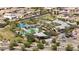 An aerial view shows community pool with shade structures and nearby Gathering homes at 14601 W Valentine St, Surprise, AZ 85379